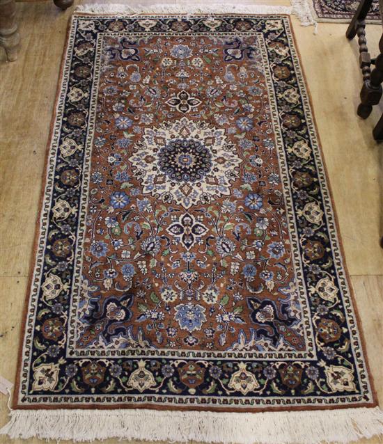 Persian pattern brown & ivory ground rug & a similar smaller rug